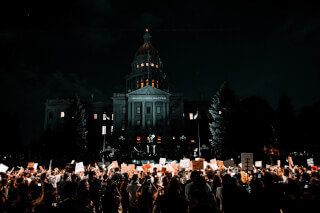 people-rallying-in-front-of-white-building-during-nightime people-rallying-in-front-of-white-building-during-nightime