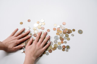 person-holding-silver-round-coins