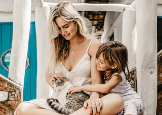 woman-and-child-sitting-while-holding-a-cat woman-and-child-sitting-while-holding-a-cat